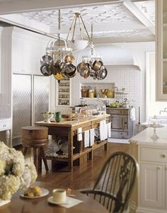 a kitchen filled with lots of white furniture