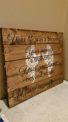 a wooden sign with an angel on it that says, dear life was a blessing