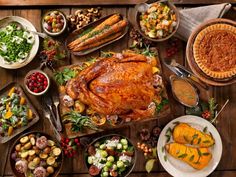 a table full of thanksgiving food including turkey, potatoes, and other foods on it