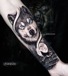 a wolf tattoo on the arm with blue eyes and an owl in it's head