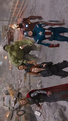 the avengers are standing together in front of a building