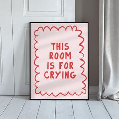 this room is for crying poster on the floor in front of a door with curtains