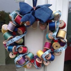 an image of a wreath made out of spools of thread and ribbons with the words u create saved to sewing - crafts