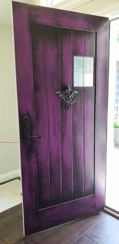 the door is painted purple and has a handle on it