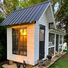 a small white house with a metal roof