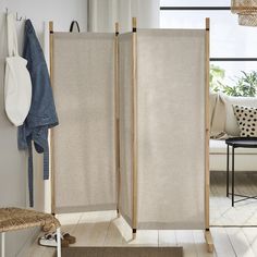 the room divider is made from wood and has two panels on each side, one with