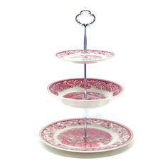 three tiered cake stand with pink and white plates on it's bottom shelf