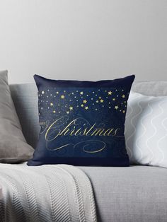 a blue and gold christmas pillow sitting on top of a couch