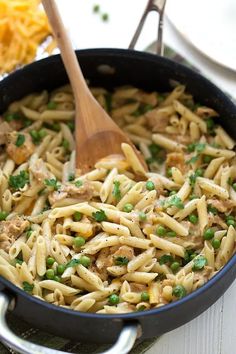 a skillet filled with pasta and peas