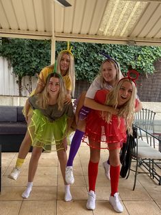 four girls dressed in costumes posing for the camera