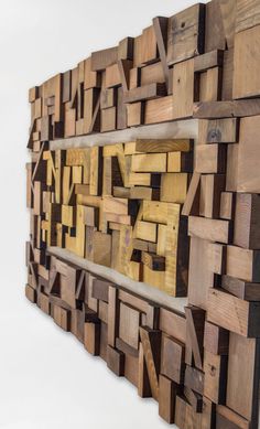 a wooden wall sculpture made out of multiple pieces of wood