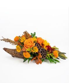 an arrangement of flowers and foliage on a white background