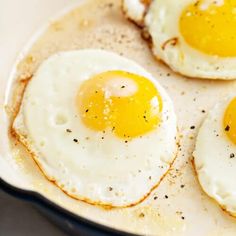 two fried eggs in a skillet on a table