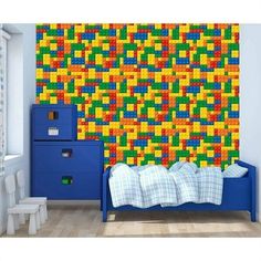 a child's bedroom with lego wallpaper and blue dresser in the foreground