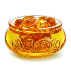 an orange glass bowl filled with gold coins