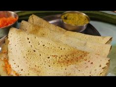 several flat breads on a plate with dipping sauce