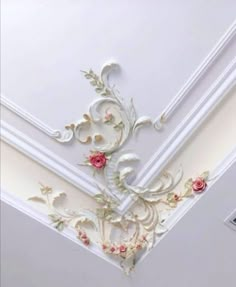 the ceiling is decorated with flowers and vines on it's sides, along with an ornate design