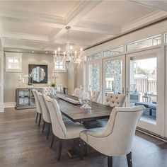 a dining room table with chairs and chandelier