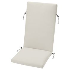 a white chair cushion with ties on the back and side, in front of a white background