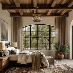 a large bed sitting under a window in a bedroom