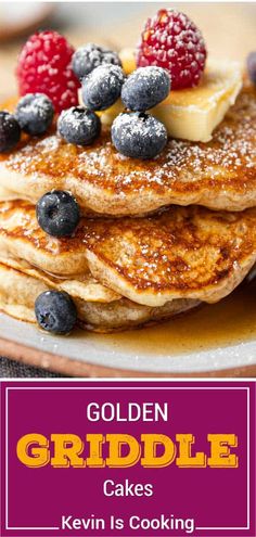 a stack of pancakes topped with blueberries and raspberries on top of each other