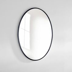 a round mirror hanging on the wall