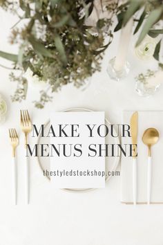 a table setting with white and gold utensils