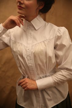 "White blouse \"Suffragette\" - perfect for any ocasion You can wear it like modern outfit, and like a part of your vintage style look Add some details, like bow tie, brooch, scarf - and you get a completely new look Composition - elastan 3%, cotton 97% On the chest, the tissue is more free, therefore the \"chest\" parameter is relative This blouse has laces at the waist, due to which you can adjust - tighten more or leave it loose. And on the back there is an elastic band. The collar and cuffs Edwardian Chemise, Brooch Scarf, Edwardian Corsets, Tie Brooch, Edwardian Blouse, Vintage Construction, Buy Blouse, Diy Scarf, Gibson Girl