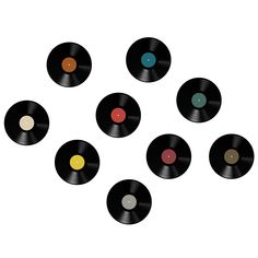 six vinyl records arranged in a circle on a white background