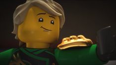 a lego man holding a cell phone in his right hand and wearing a green outfit