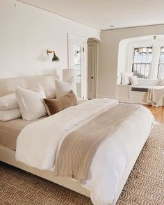 a large bed sitting in the middle of a bedroom