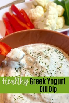 healthy greek yogurt dill dip with carrots and cauliflower in the background