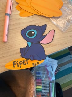 a table topped with paper cut outs and markers