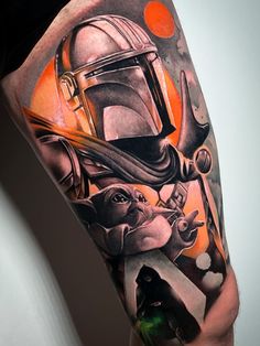 a man's arm with a star wars tattoo on it and an image of boba fett