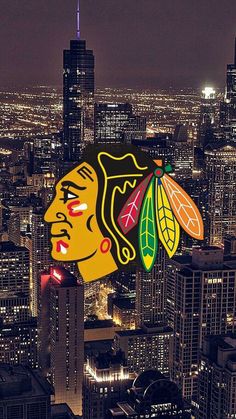 an aerial view of the city at night with lights on and a chicago black hawks logo