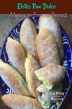 mexican sweet bread is cut in half and placed on a blue plate with the words, elotes pan dulce mexican sweet bread