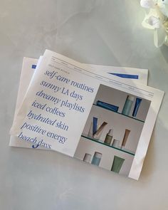 two newspapers with different types of items on them sitting on a table next to flowers