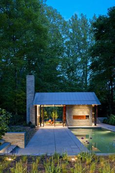 an outdoor pool surrounded by trees and plants