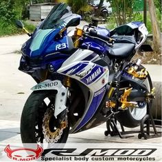 a blue and white motorcycle parked on the street