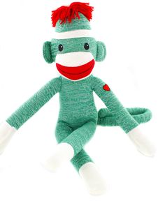 a green sock monkey stuffed animal with red hair and eyes sitting on a white background