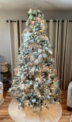 a white christmas tree with blue and silver decorations