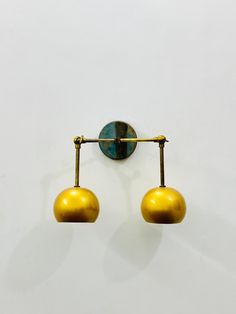 two lights are attached to the wall in front of a white background with blue and gold accents