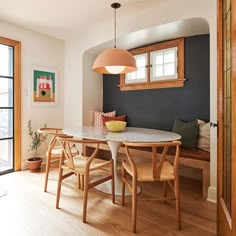 a dining room table and chairs in front of a window