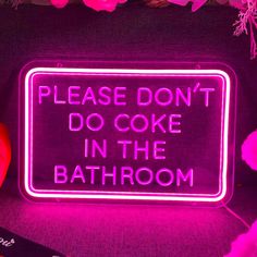 a neon sign that says, please don't do cake in the bath room