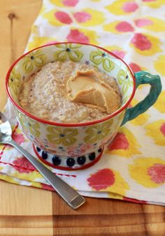 a bowl of oatmeal with peanut butter in it on a floral napkin