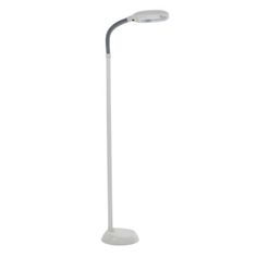 the floor lamp is white and has a light on it's side, with a dim