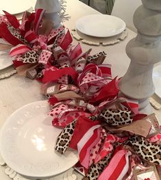 the table is decorated with red and white ribbons