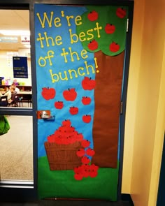 an apple themed classroom door with the words, we're the best of the bunch