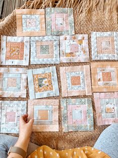 someone is working on some quilts that have been made into squares and rectangles