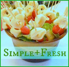 a bowl filled with pasta and veggies on top of a table